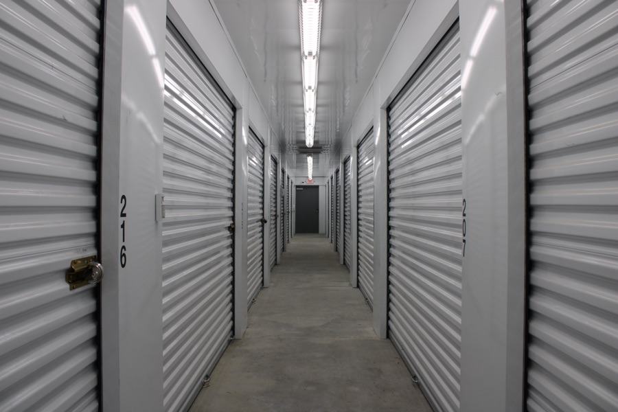 Interior corridor of climate-controlled storage units with white roll-up doors
